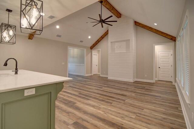 3039 Mary Powell Way, Hahira, GA 31632 - kitchen with green cabinets, wood finished floors, open floor plan, light countertops, and recessed lighting