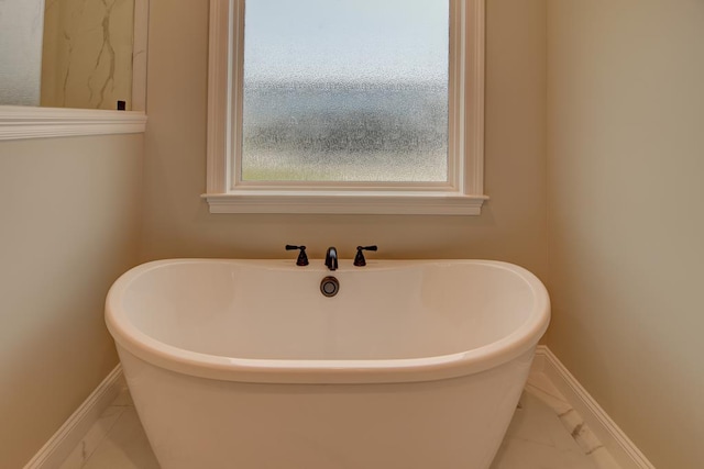 3039 Mary Powell Way, Hahira, GA 31632 - full bathroom with marble finish floors, baseboards, and a freestanding bath