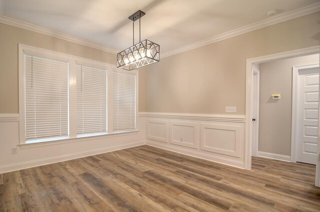 3039 Mary Powell Way, Hahira, GA 31632 - unfurnished dining area with a chandelier, crown molding, dark wood-style floors, and wainscoting