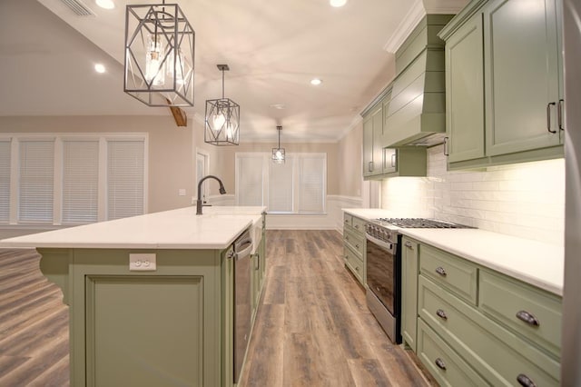 3039 Mary Powell Way, Hahira, GA 31632 - kitchen with green cabinets, appliances with stainless steel finishes, a kitchen island with sink, light countertops, and recessed lighting