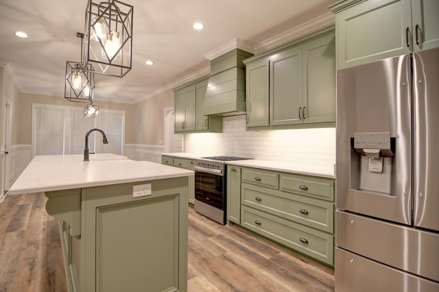 3039 Mary Powell Way, Hahira, GA 31632 - kitchen featuring green cabinetry, appliances with stainless steel finishes, a sink, crown molding, and an island with sink