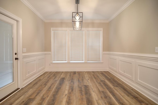 3039 Mary Powell Way, Hahira, GA 31632 - unfurnished dining area with crown molding, wainscoting, dark wood-type flooring, and a decorative wall