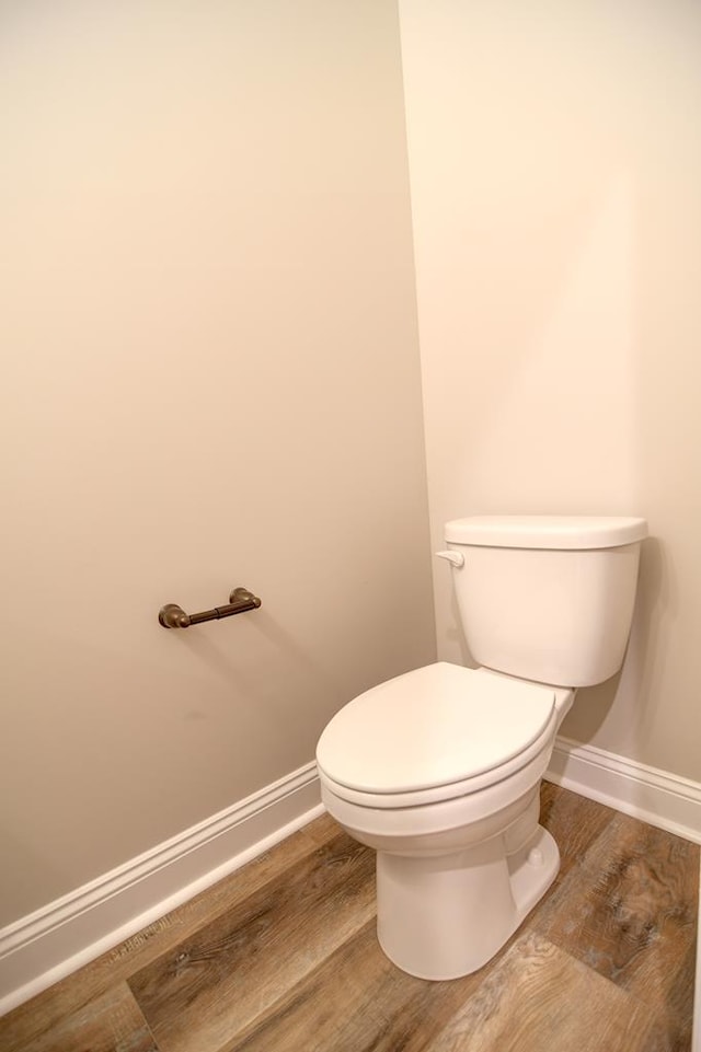 3039 Mary Powell Way, Hahira, GA 31632 - bathroom featuring baseboards, wood finished floors, and toilet
