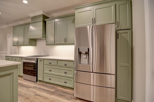 3039 Mary Powell Way, Hahira, GA 31632 - kitchen featuring stainless steel appliances, green cabinets, crown molding, light countertops, and backsplash