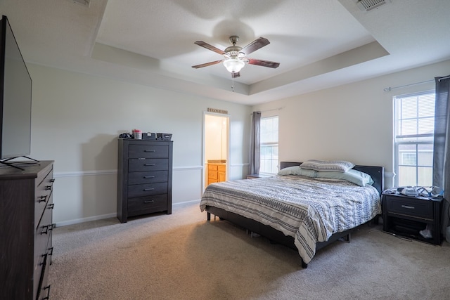 5187 Calvary Cir, Valdosta, GA 31605 - bedroom featuring a tray ceiling, light colored carpet, and ceiling fan