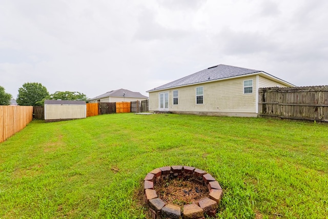 5187 Calvary Cir, Valdosta, GA 31605 - back of property with a fire pit, a fenced backyard, and a shed