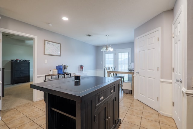 5187 Calvary Cir, Valdosta, GA 31605 - kitchen with light tile patterned floors, dark countertops, dark cabinetry, recessed lighting, and a chandelier