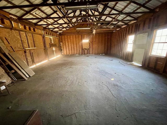 misc room featuring a garage and vaulted ceiling
