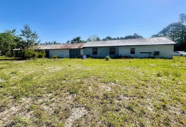 back of house with metal roof