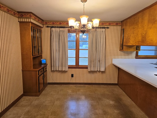 unfurnished dining area featuring a chandelier