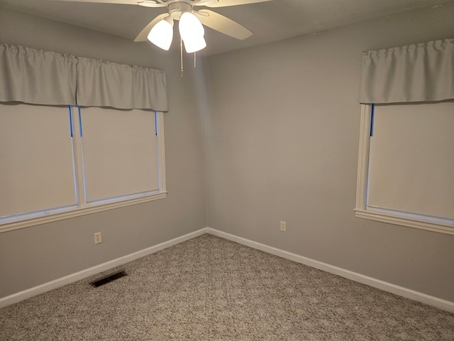 unfurnished room with ceiling fan and carpet