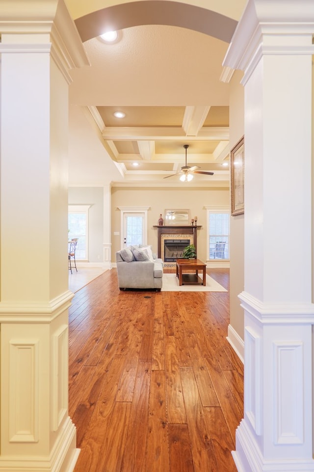 5080 Carlton Ridge Cir, Hahira, GA 31632 - hall with arched walkways, light wood-style floors, coffered ceiling, plenty of natural light, and beamed ceiling