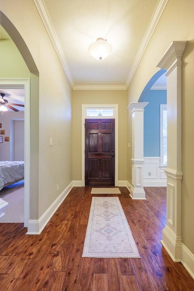 5080 Carlton Ridge Cir, Hahira, GA 31632 - entrance foyer featuring wood finished floors, arched walkways, ceiling fan, crown molding, and decorative columns