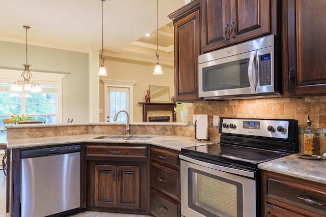 5080 Carlton Ridge Cir, Hahira, GA 31632 - kitchen with appliances with stainless steel finishes, ornamental molding, dark brown cabinets, healthy amount of natural light, and decorative backsplash