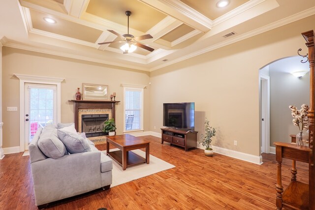 5080 Carlton Ridge Cir, Hahira, GA 31632 - living room featuring a fireplace, arched walkways, ornamental molding, ceiling fan, and coffered ceiling