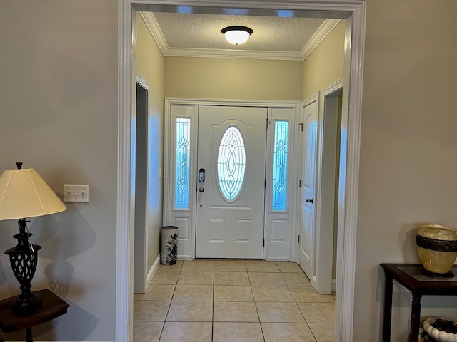 foyer entrance with a textured ceiling, crown molding, and light tile patterned flooring