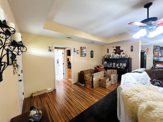 5612 Emily Ln, Hahira, GA 31632 - bedroom with wood-type flooring, a tray ceiling, and a ceiling fan