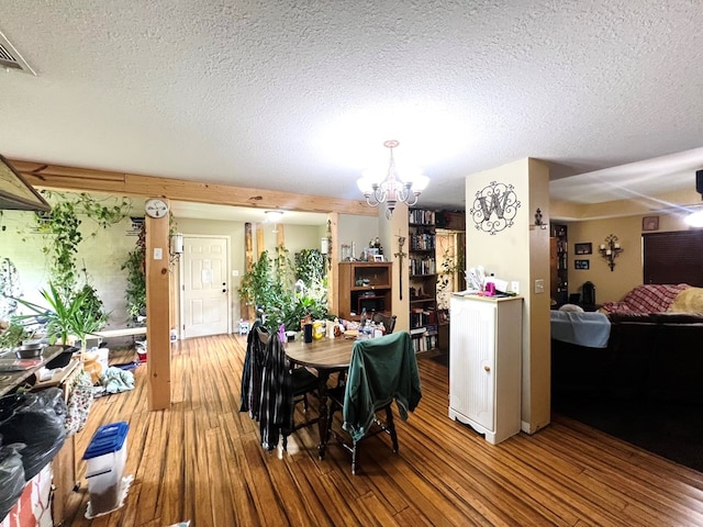 5612 Emily Ln, Hahira, GA 31632 - dining room featuring a chandelier, wood finished floors, and a textured ceiling