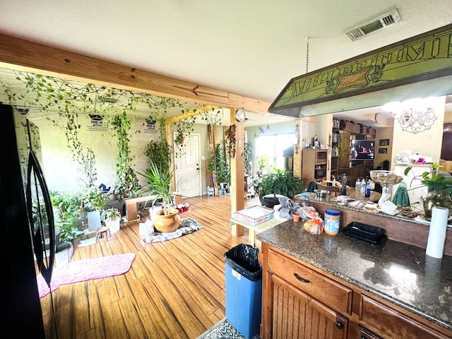 5612 Emily Ln, Hahira, GA 31632 - bar with freestanding refrigerator and wood finished floors