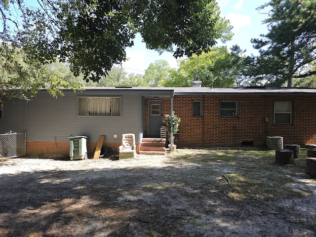 view of front of property with central air condition unit and crawl space