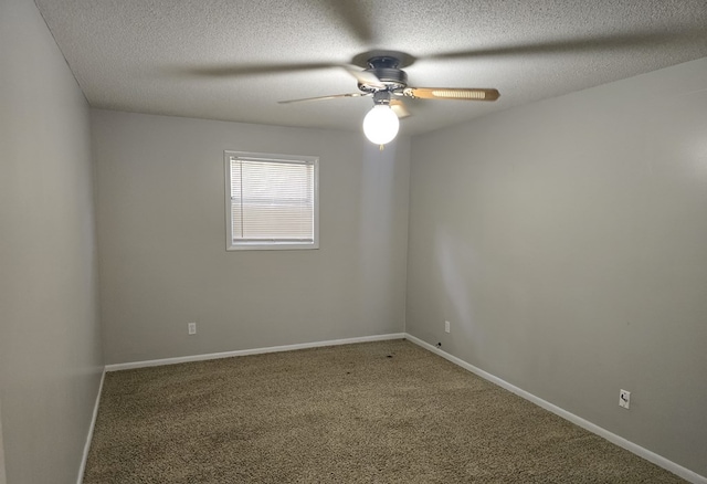 unfurnished room with carpet, a textured ceiling, baseboards, and a ceiling fan
