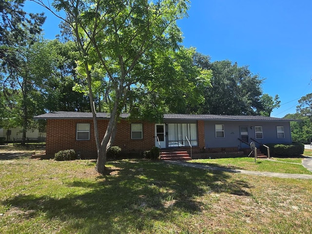 single story home with a front yard and brick siding