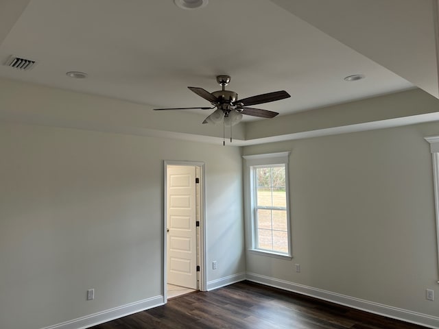 spare room with ceiling fan and dark wood-type flooring