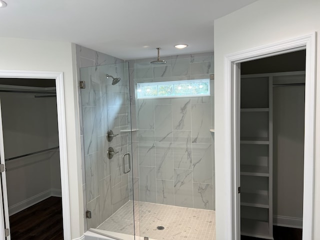 bathroom featuring hardwood / wood-style flooring and a shower with shower door