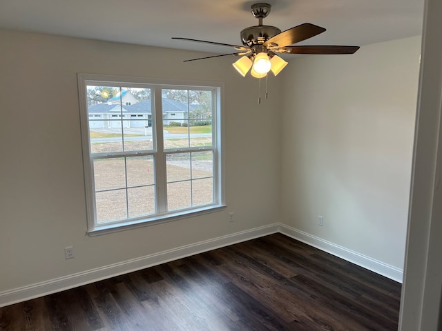 empty room with dark hardwood / wood-style floors and ceiling fan