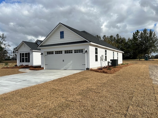 view of front of home featuring a garage and cooling unit