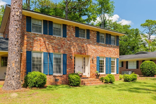 812 Tanglewood Dr, Valdosta, GA 31602 - colonial inspired home with brick siding, a front lawn, and central AC