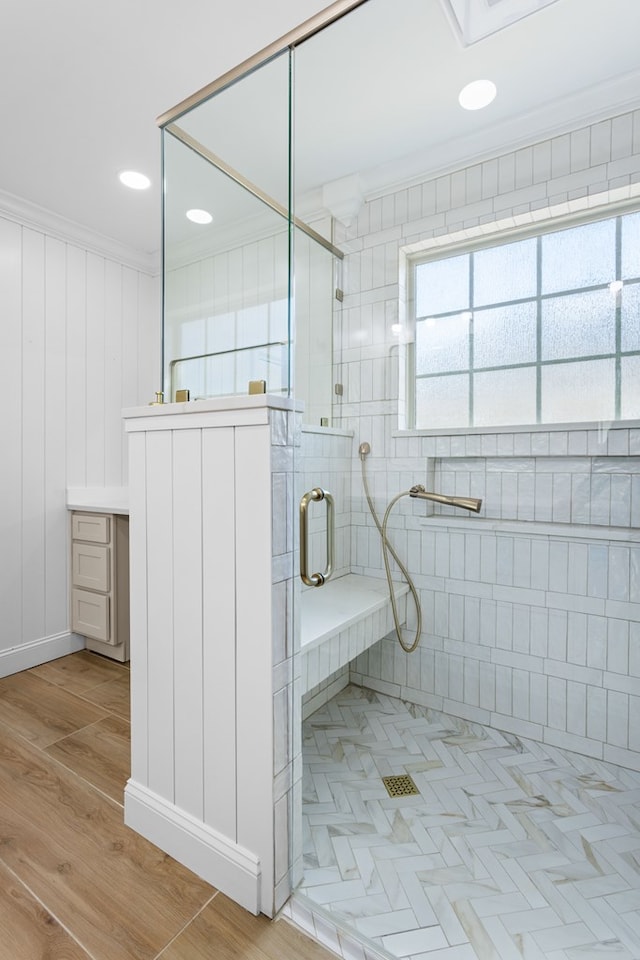 full bath featuring a shower stall, ornamental molding, wood finished floors, and recessed lighting