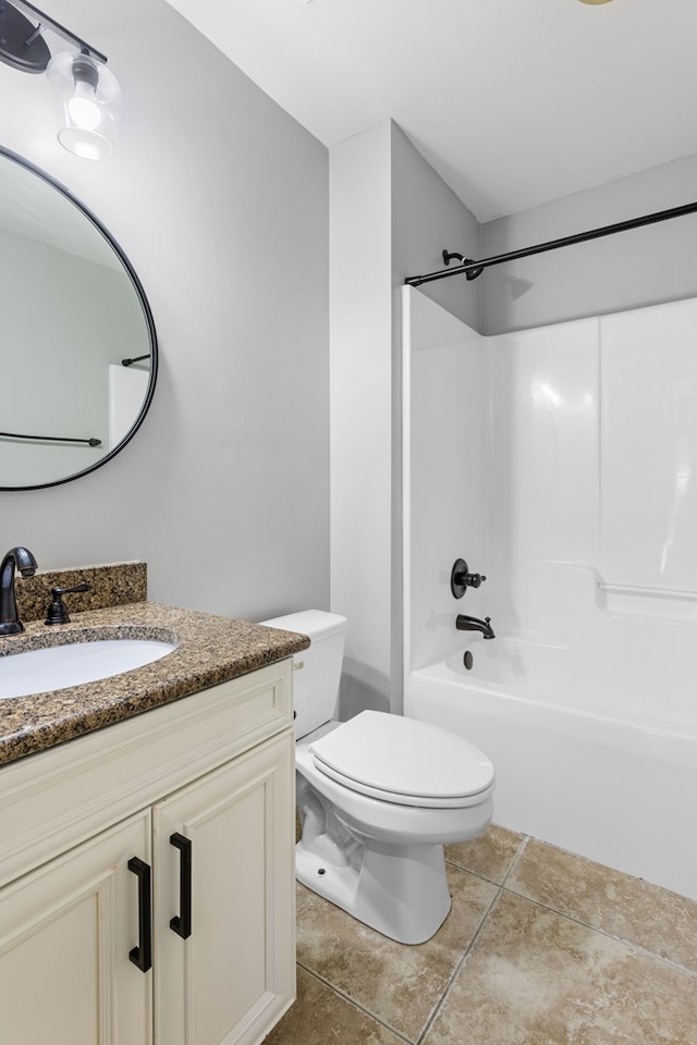 bathroom with washtub / shower combination, tile patterned flooring, vanity, and toilet