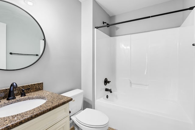 bathroom with washtub / shower combination, vanity, and toilet