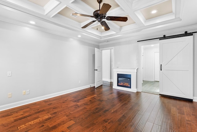 unfurnished living room with dark wood-type flooring, coffered ceiling, crown molding, and a barn door