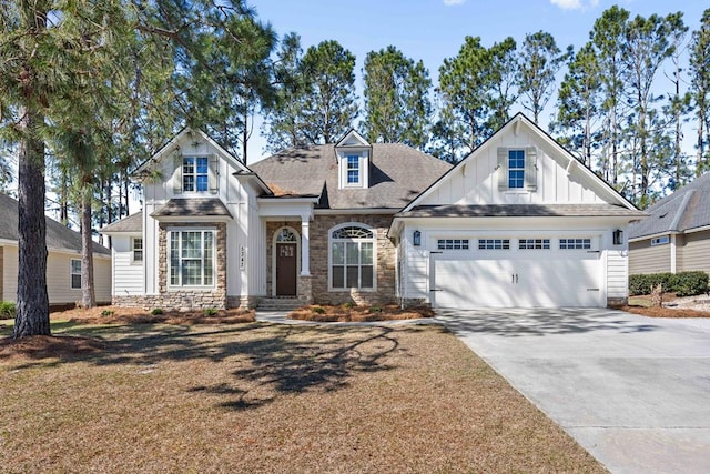 craftsman-style home featuring an attached garage, stone siding, board and batten siding, and concrete driveway