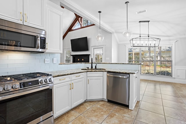 kitchen with a sink, visible vents, vaulted ceiling, appliances with stainless steel finishes, and crown molding