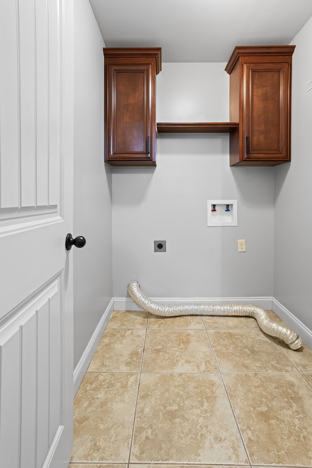 laundry room with hookup for a washing machine, cabinet space, hookup for an electric dryer, tile patterned flooring, and baseboards