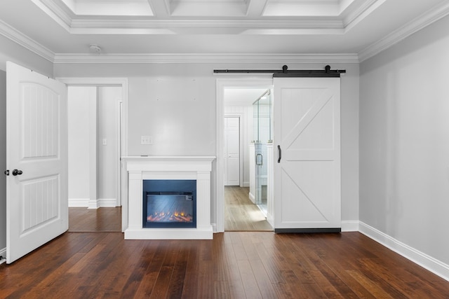 unfurnished living room featuring a barn door, baseboards, a glass covered fireplace, ornamental molding, and dark wood-style flooring