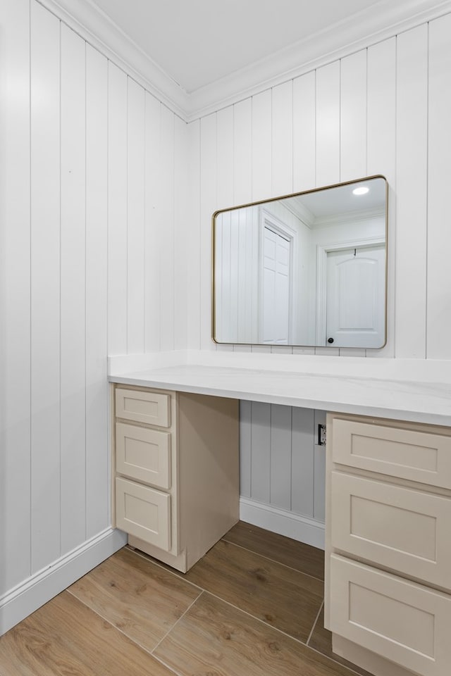 bathroom featuring ornamental molding and wood finished floors