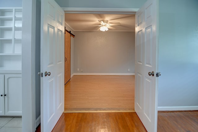 2321 Frederick Pl, Valdosta, GA 31602 - spare room featuring wood finished floors, a barn door, ceiling fan, and crown molding