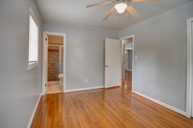 2321 Frederick Pl, Valdosta, GA 31602 - unfurnished bedroom with wood-type flooring, connected bathroom, and a ceiling fan