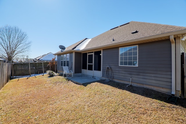 rear view of house featuring a yard and a patio area