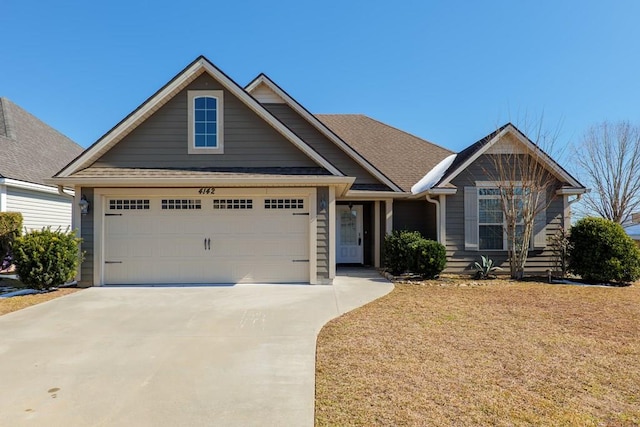 craftsman-style home with a garage and a front lawn