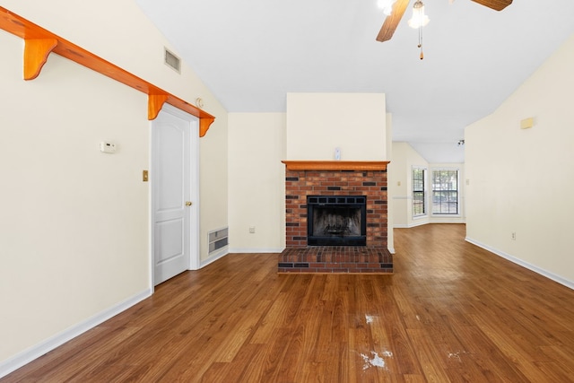 4312 Shiloh Trce, Valdosta, GA 31602 - unfurnished living room with wood finished floors, vaulted ceiling, a fireplace, ceiling fan, and baseboards