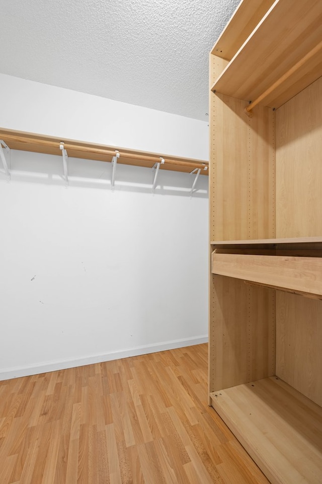 4312 Shiloh Trce, Valdosta, GA 31602 - walk in closet featuring wood finished floors