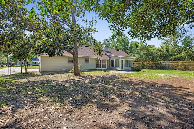 4312 Shiloh Trce, Valdosta, GA 31602 - rear view of house with a fenced backyard and a sunroom