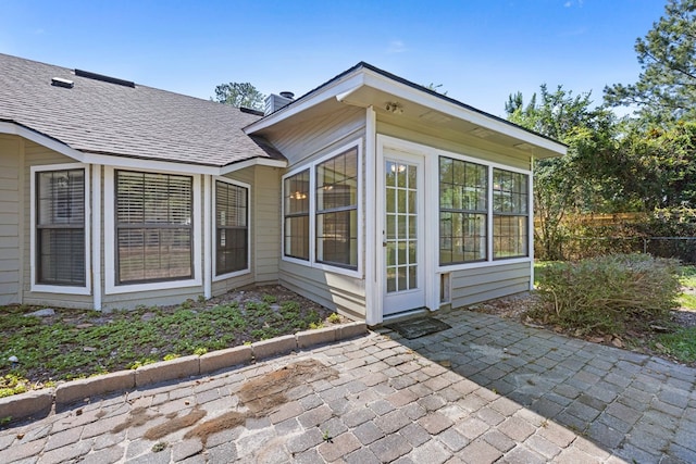 4312 Shiloh Trce, Valdosta, GA 31602 - view of side of home featuring roof with shingles, a patio area, a sunroom, and fence
