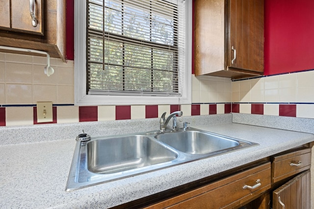 4312 Shiloh Trce, Valdosta, GA 31602 - kitchen featuring a sink, tasteful backsplash, light countertops, and brown cabinets