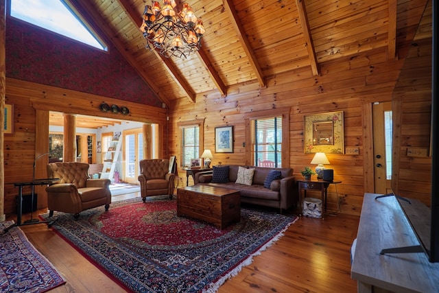 living room featuring hardwood / wood-style floors, a healthy amount of sunlight, and high vaulted ceiling